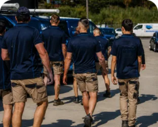 Plumbers walking to their service vans on a Engadine job